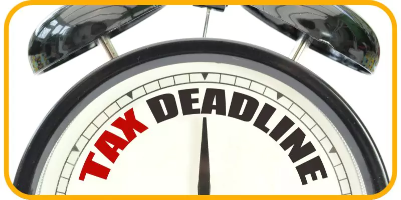Penalty for Late Tax Filing in Canada: What You Need to Know in 2025 1 A clock with tax deadline written on it