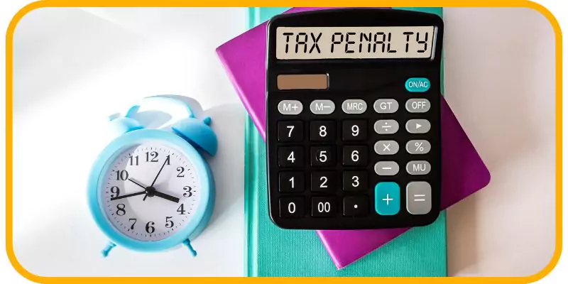 Penalty for Late Tax Filing in Canada: What You Need to Know in 2025 2 A calculator keypad with tax penalty writtenb on it and central clock placed in table
